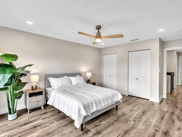 an aerial view of residential houses with outdoor space and lake view