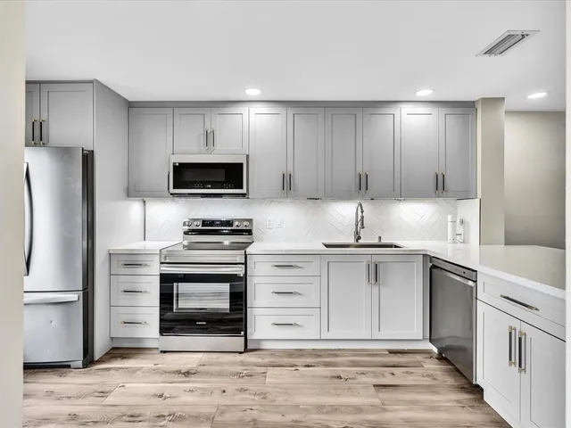 a view of living room with furniture and potted plant