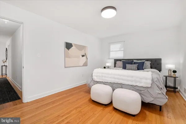 a bedroom with bed and wooden floor