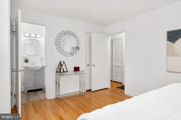 a view of a bedroom with a bed and workspace