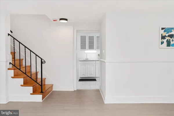 a view of entryway and hall with wooden floor