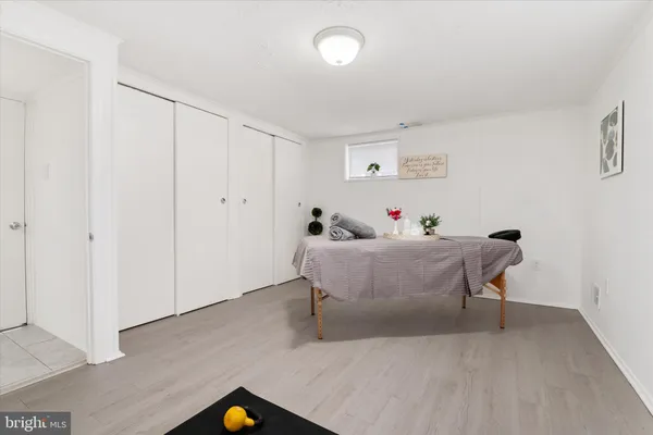 a bedroom with a bed and a potted plant