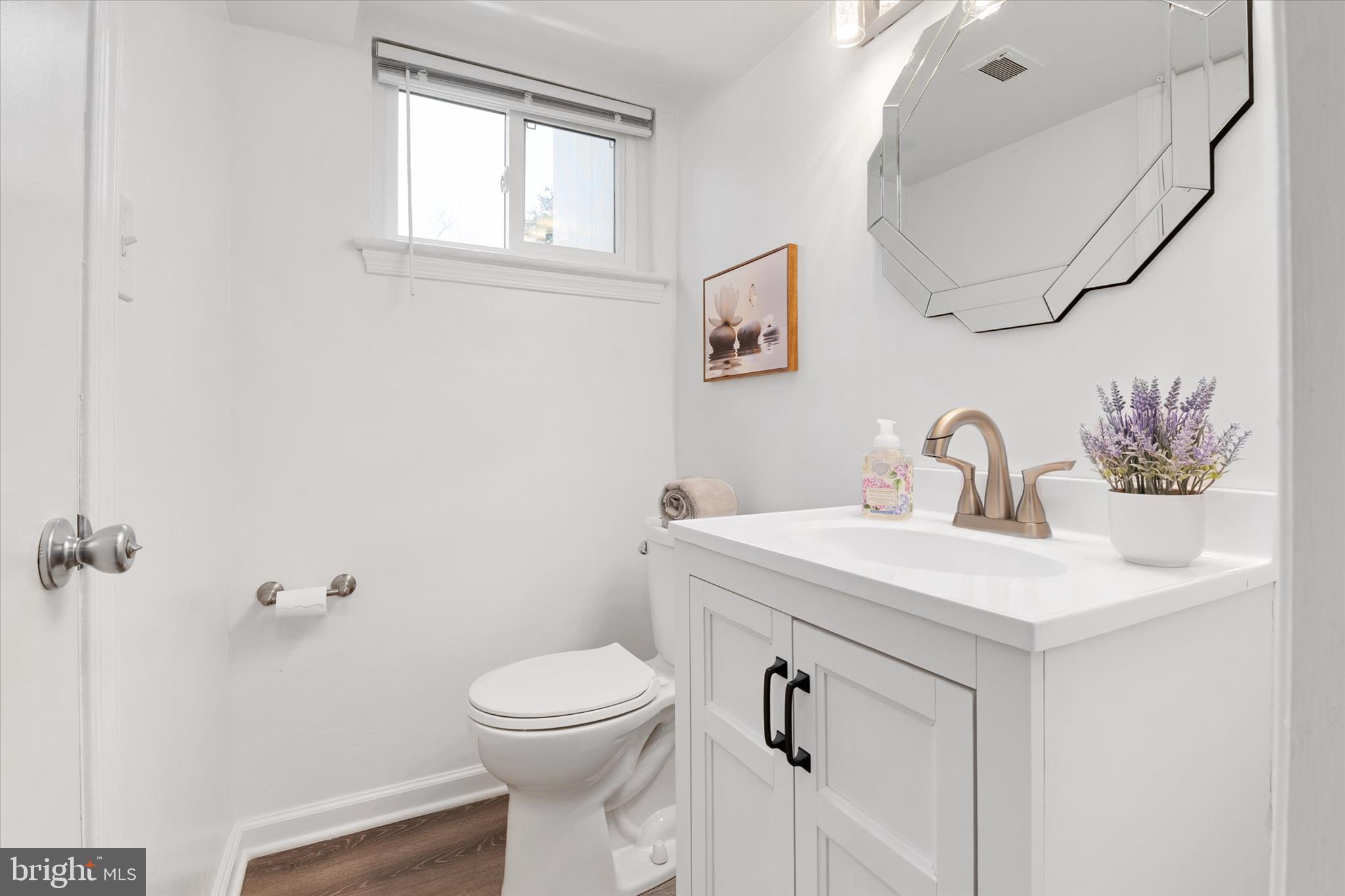 11006 Childs Street Silver Spring, MD 20901 - Photo 31 of 42 a bathroom with a toilet sink and mirror