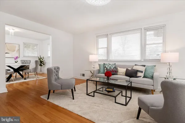 a living room with furniture and a lamp