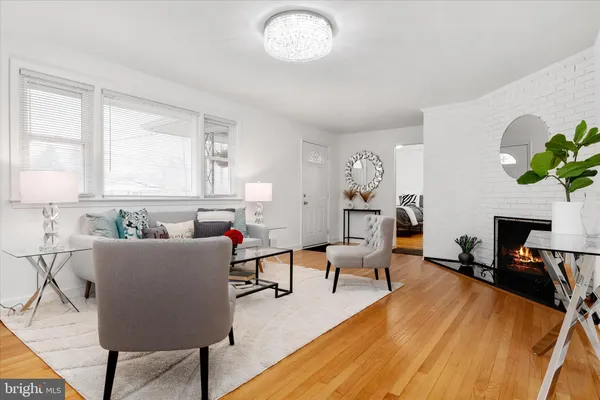 a living room with furniture a fireplace and a table