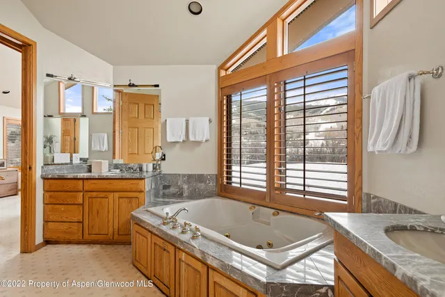a spacious bathroom with a granite countertop tub and a sink