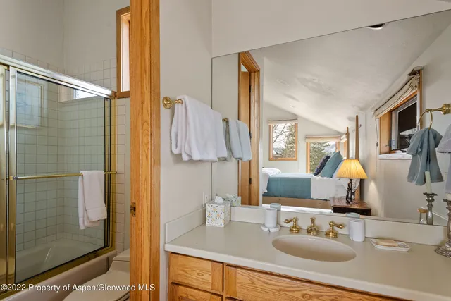 a bathroom with a sink double vanity and shower