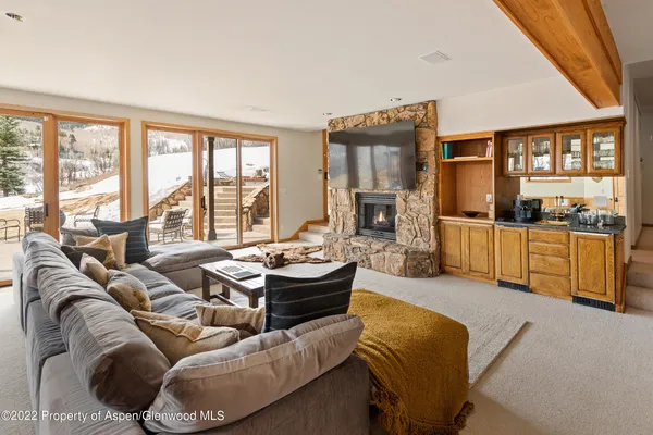 a living room with furniture and a floor to ceiling window