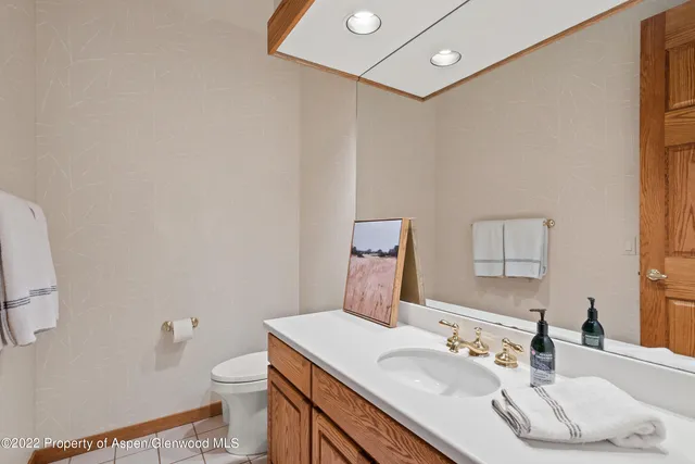 a bathroom with a sink a toilet and mirror