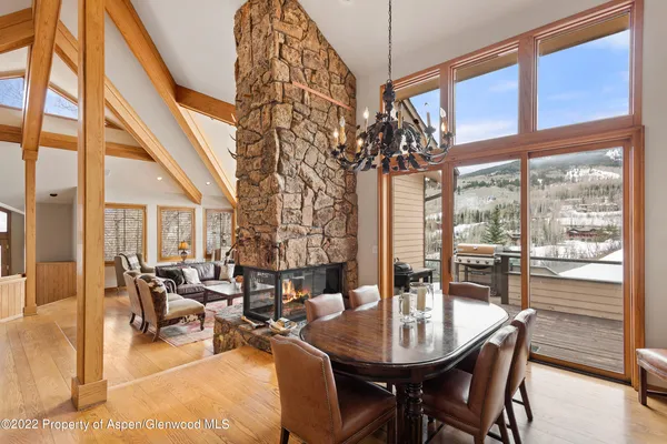 a dining room with furniture a chandelier and wooden floor