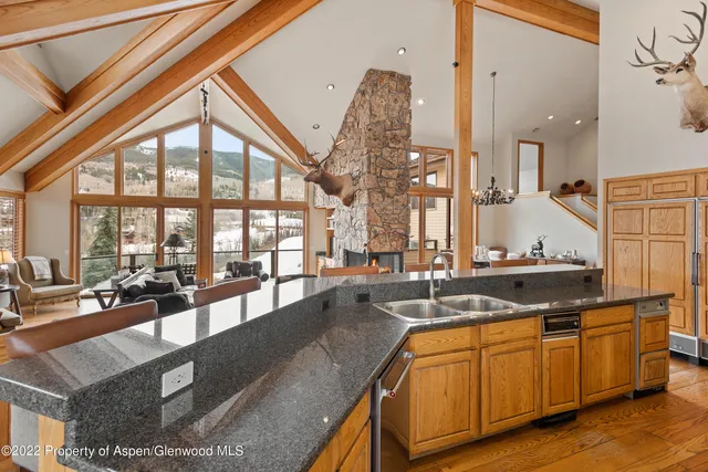 a view of a kitchen with granite countertop a sink and a counter top space