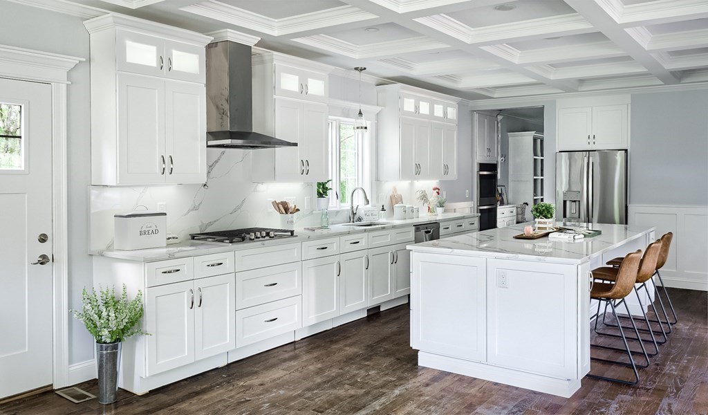 a kitchen with kitchen island granite countertop white cabinets and white appliances