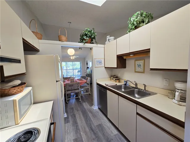 a kitchen with cabinets a sink and appliances