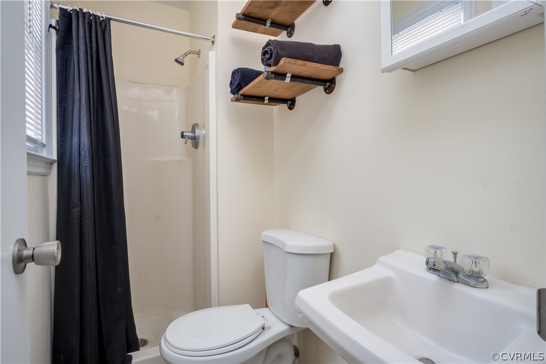 15948 Sandwave Road Chester, VA 23831 - Photo 18 of 22 a white toilet sitting next to a bathroom sink
