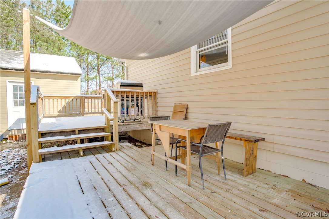 15948 Sandwave Road Chester, VA 23831 - Photo 20 of 22 a view of a patio with table and chairs with wooden floor and fence