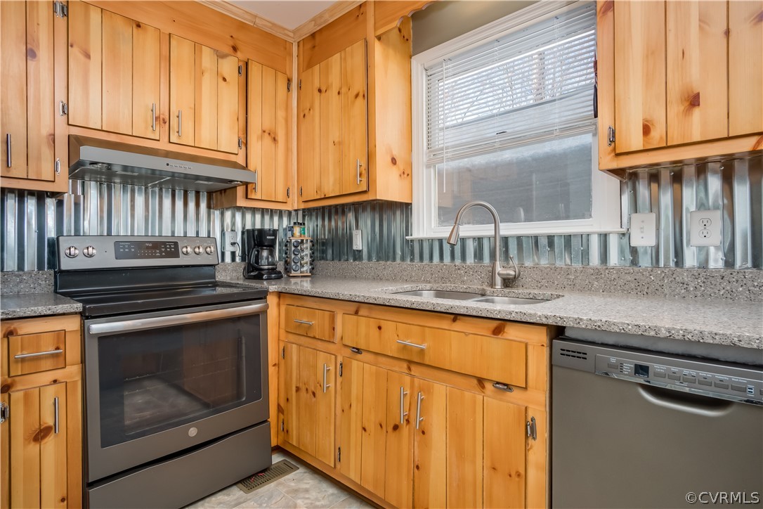 15948 Sandwave Road Chester, VA 23831 - Photo 9 of 22 a kitchen with granite countertop a sink stove and cabinets