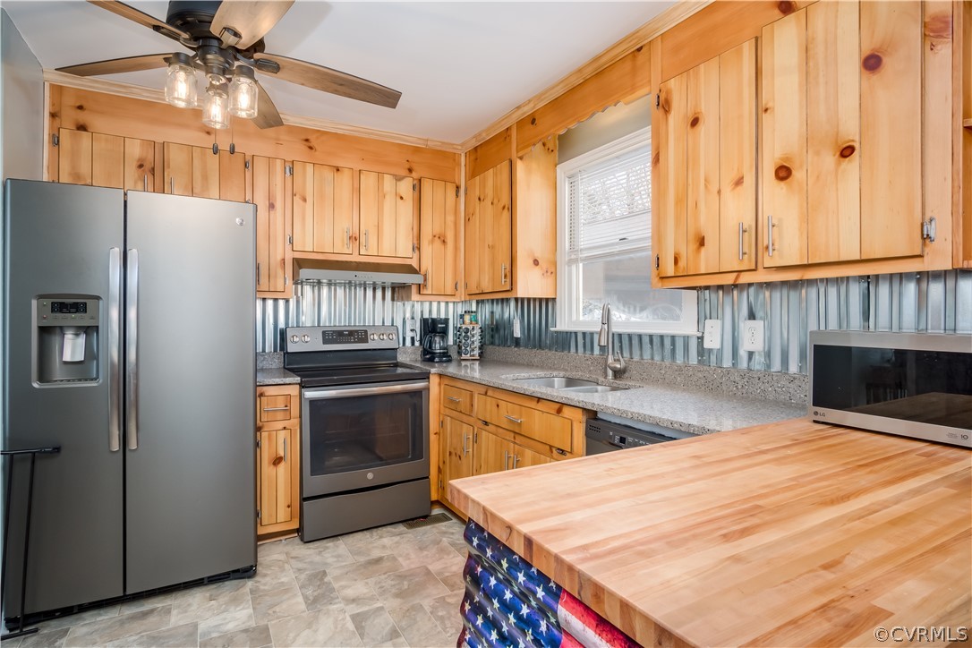 15948 Sandwave Road Chester, VA 23831 - Photo 10 of 22 a kitchen with stainless steel appliances granite countertop a refrigerator a sink dishwasher a stove with wooden cabinets and floor