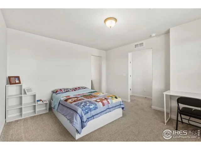 a bedroom with a bed and a table in it