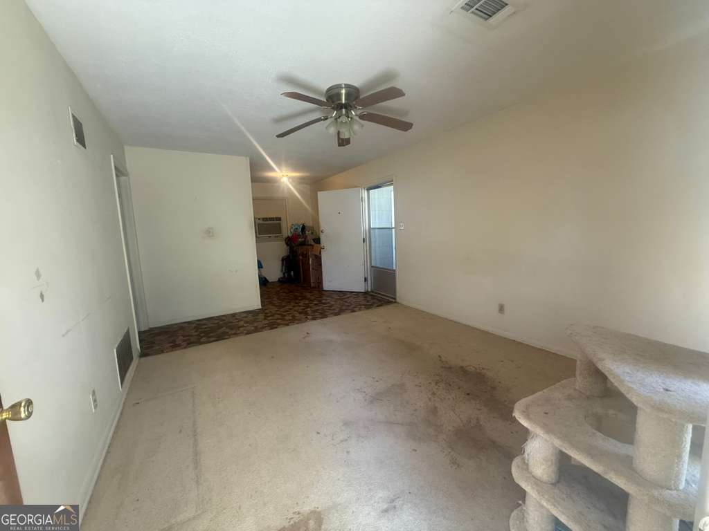 108 Sunset Drive Eufaula, AL 36027 - Photo 2 of 12 a view of a livingroom with a ceiling fan and entryway