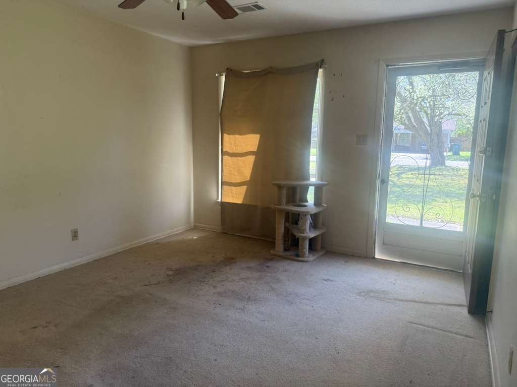 108 Sunset Drive Eufaula, AL 36027 - Photo 3 of 12 an empty room with windows and fireplace