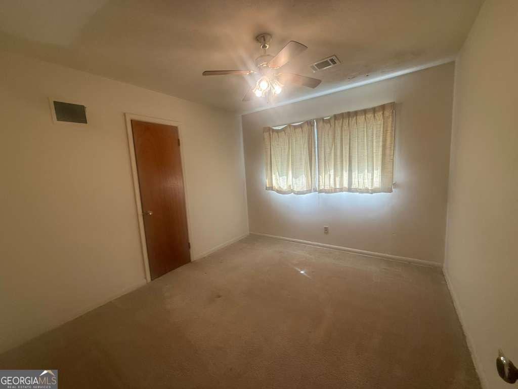 108 Sunset Drive Eufaula, AL 36027 - Photo 7 of 12 a view of an empty room and window