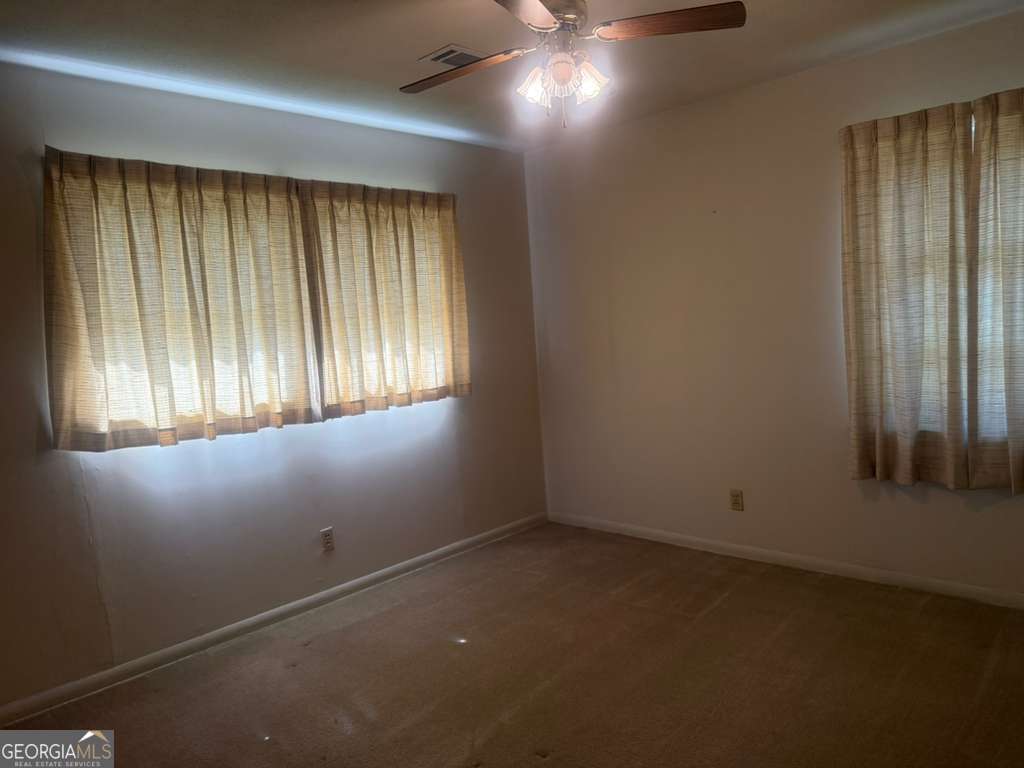 108 Sunset Drive Eufaula, AL 36027 - Photo 8 of 12 an empty room with windows