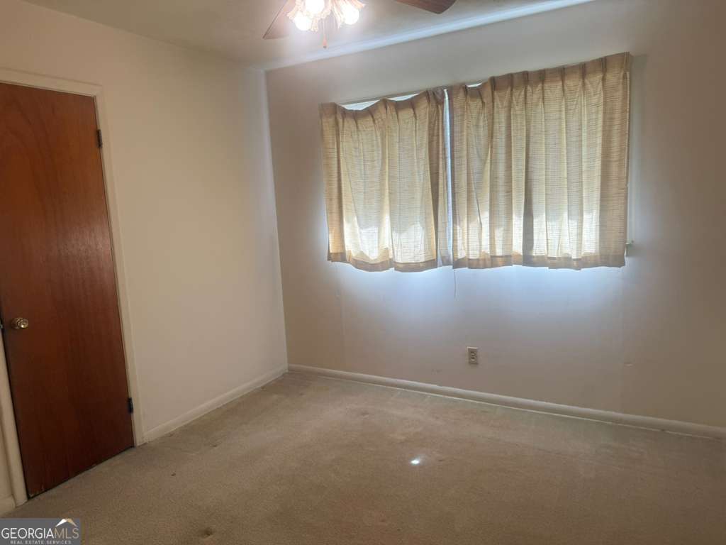 108 Sunset Drive Eufaula, AL 36027 - Photo 10 of 12 an empty room with windows