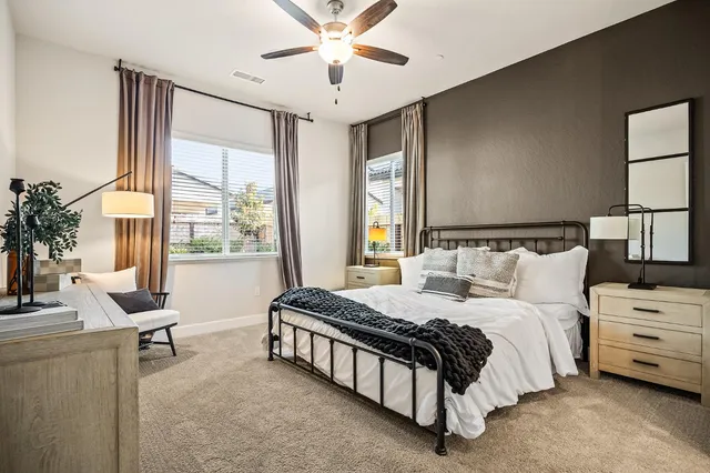 a spacious bedroom with a bed and a chandelier