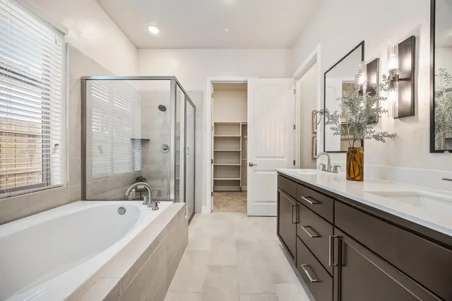 a bathroom with a double vanity sink and mirror