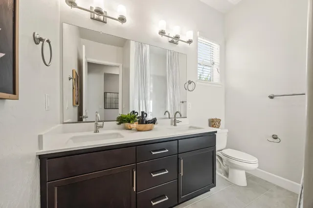 a kitchen with stainless steel appliances a table and chairs in it