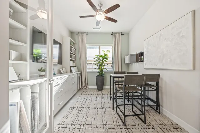 a view of a workspace with furniture and a potted plant