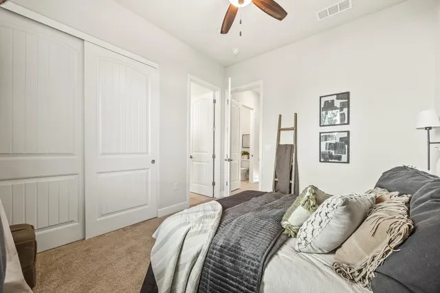 a bathroom with a double vanity sink toilet and a mirror