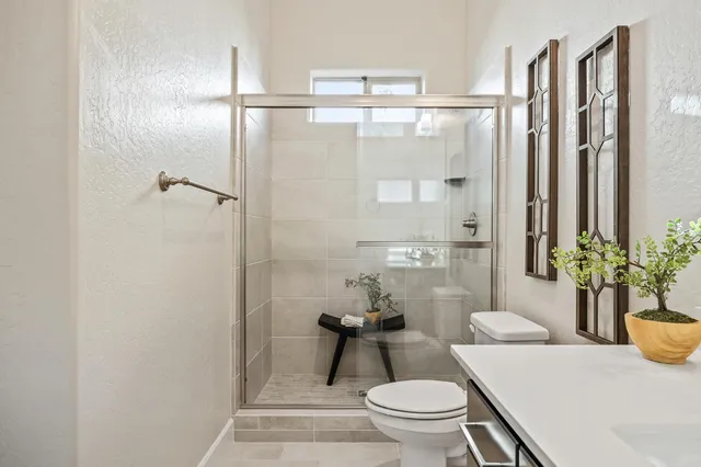 an aerial view of a houses with street