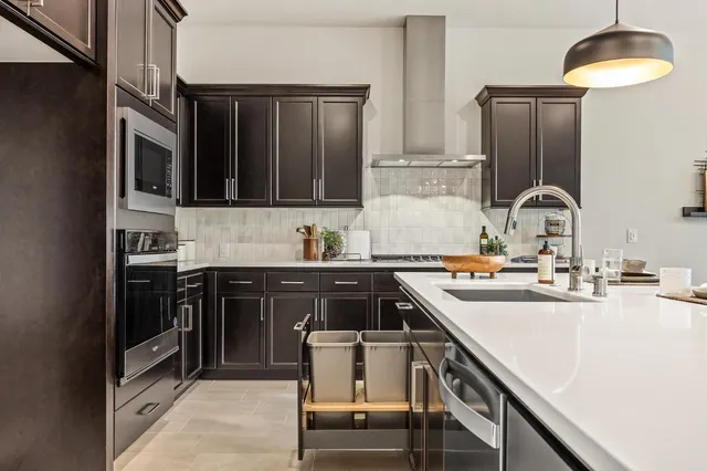 a kitchen with a sink a stove and cabinets