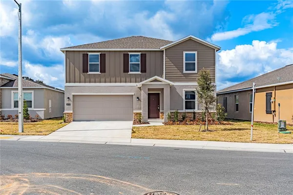 a view of a house with swimming pool and sitting area