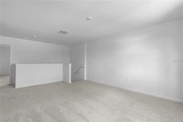 a view of an empty room and a window