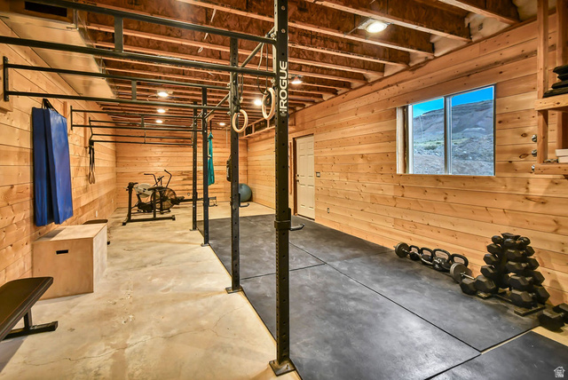 544 East 600 North, Unit 1 Joseph, UT 84739 - Photo 49 of 65 Dedicated fitness space featuring wood-paneled walls, exposed ceiling joists, and concrete flooring