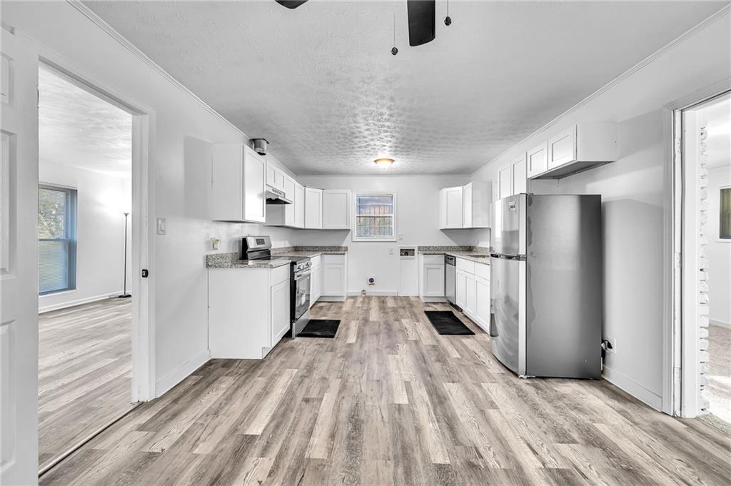 2356 County Line Road Southwest Atlanta, GA 30331 - Photo 11 of 22 a kitchen with stainless steel appliances granite countertop a refrigerator and a stove top oven