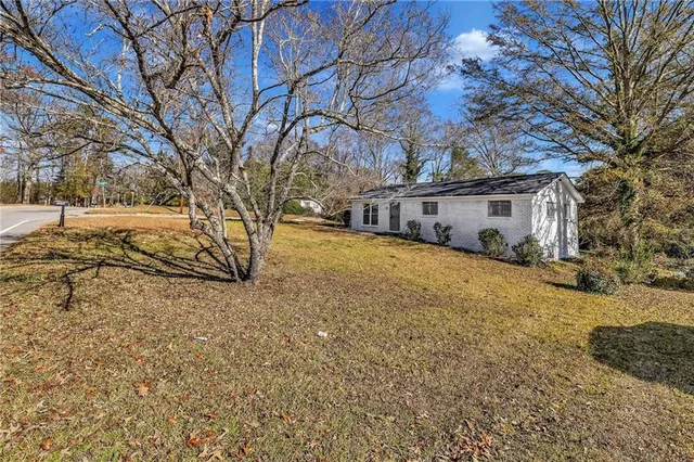 a view of a yard with a large tree