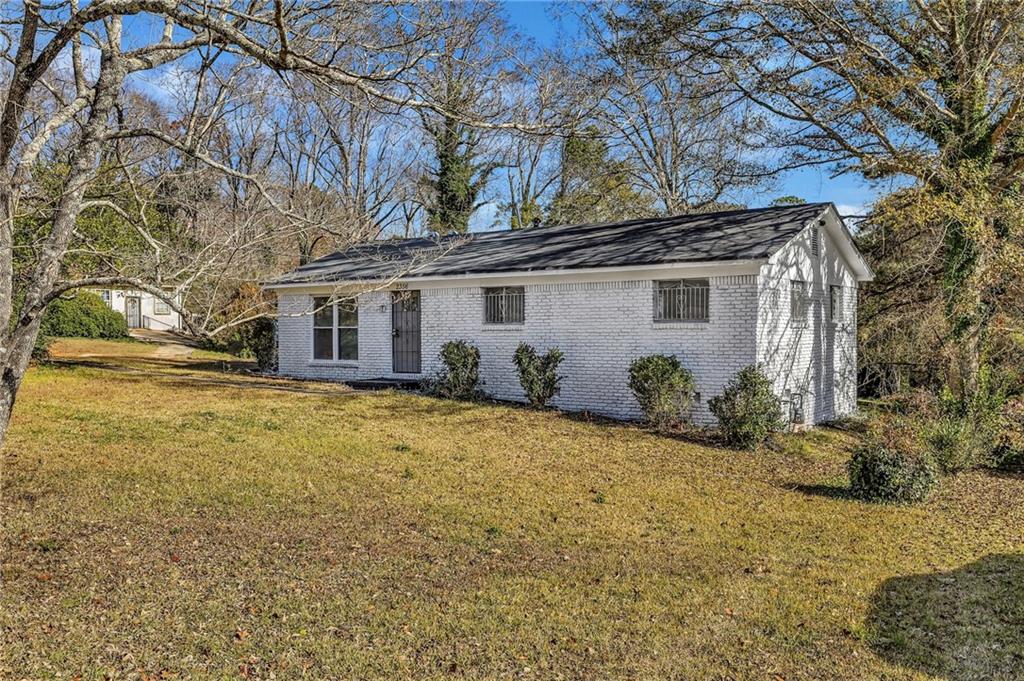 2356 County Line Road Southwest Atlanta, GA 30331 - Photo 5 of 22 a front view of a house with a yard