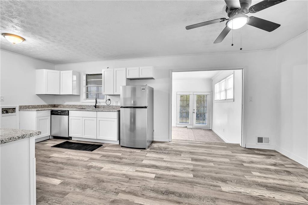 2356 County Line Road Southwest Atlanta, GA 30331 - Photo 10 of 22 a kitchen with white cabinets and stainless steel appliances