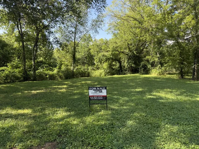 a backyard of a house with a yard and outdoor seating