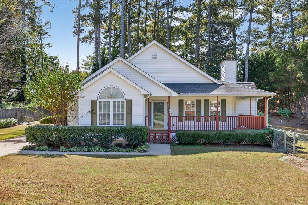 249 Russell Road Winder, GA 30680 - Photo 1 of 1 a front view of a house with a yard and potted plants