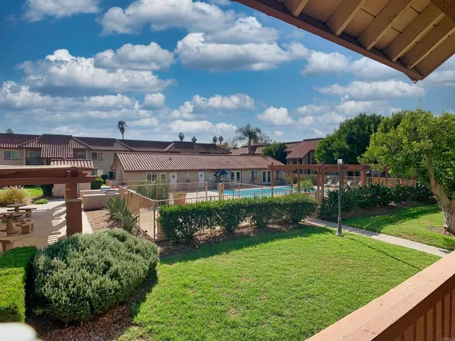 a view of a garden with a building in the background
