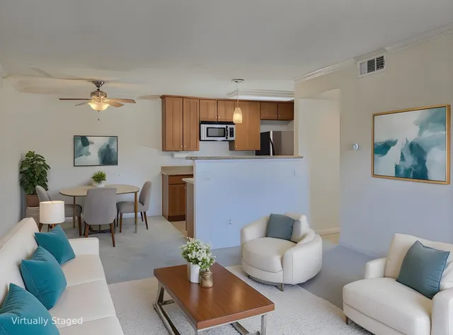 a living room with furniture and a potted plant
