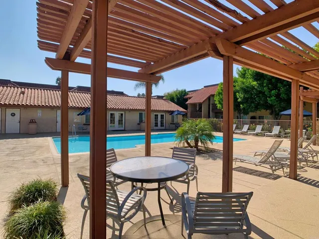 a backyard of a house with table and chairs