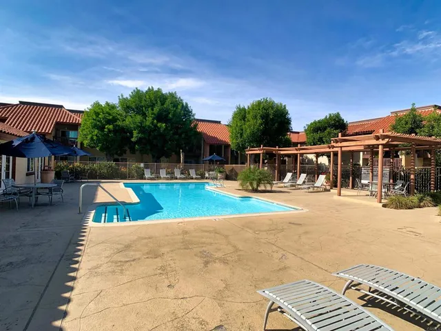 swimming pool view with a seating space