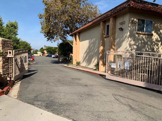 a view of a house with wooden fence