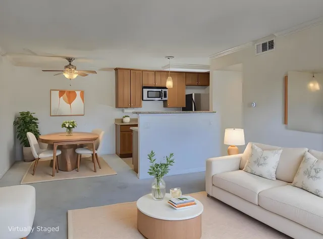 a living room with furniture a chandelier and a dining room