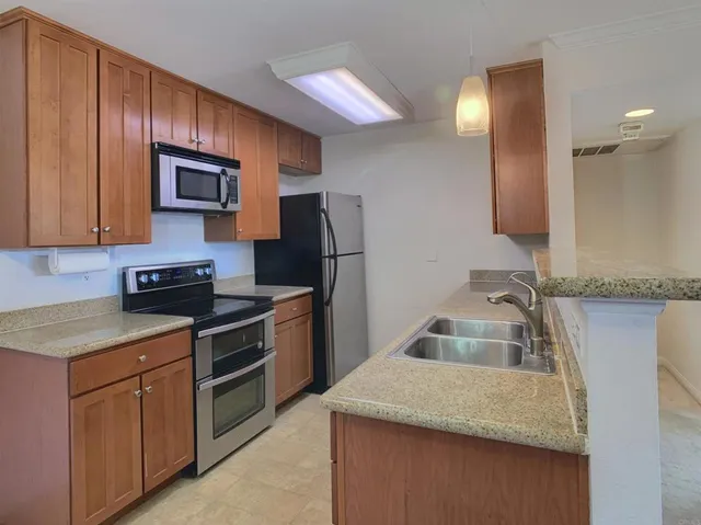 a kitchen that has a sink and a stove in it